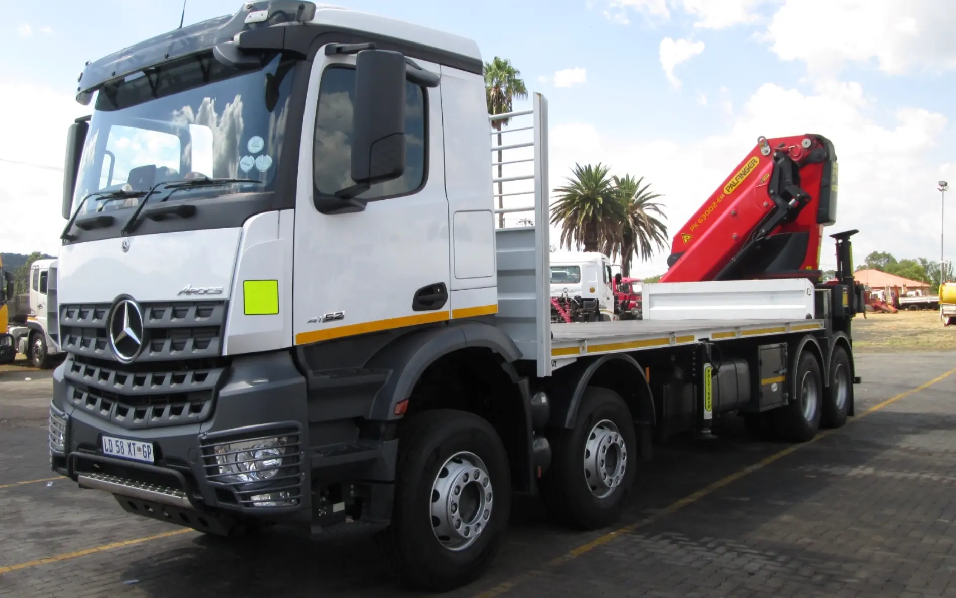 Mercedes-Benz Arocs 8x4 flat deck truck with rear-mounted PALFINGER PK63002 EH knuckle-boom crane